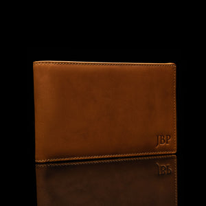 Example of embossed initials on a leather passport personalized wallet by Von Baer.