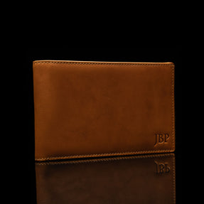 Example of embossed initials on a leather passport personalized wallet by Von Baer.