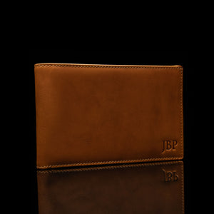 Example of embossed initials on a leather passport personalized wallet by Von Baer.