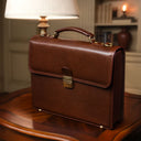 Von Baer diplomat luxurious compact full-grain leather briefcase for men in a classic luxury office with vintage lamp interior.