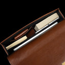 Slim full-grain leather briefcase interior top view with laptop, books, and accessories for professional work by Von Baer Diplomat.