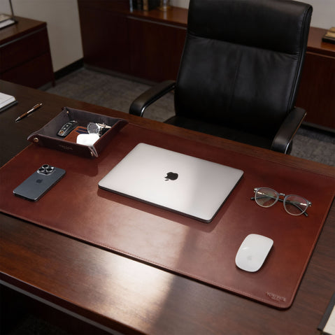 Von Baer Executive luxury full-grain leather desk pad in brown on a CEO office table with MacBook, professional desk accessory.