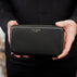 Von Baer origin luxury RFID men’s leather wallet in black held by a male model, premium wallet for cards and cash.