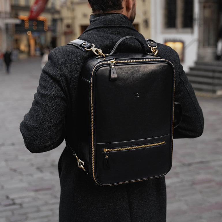 Von Baer 10x high-quality leather travel backpack in black, worn by a good-looking man.