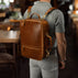 Von Baer 10x luxury leather laptop travel backpack in tan color, worn in the cafe.