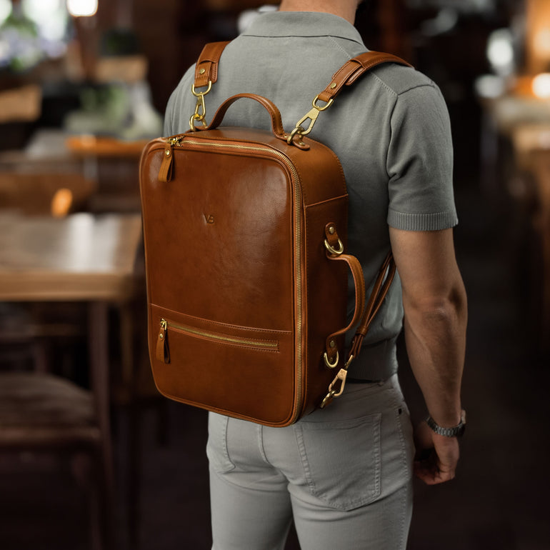 Von Baer 10x luxury leather laptop travel backpack in tan color, worn in the cafe.