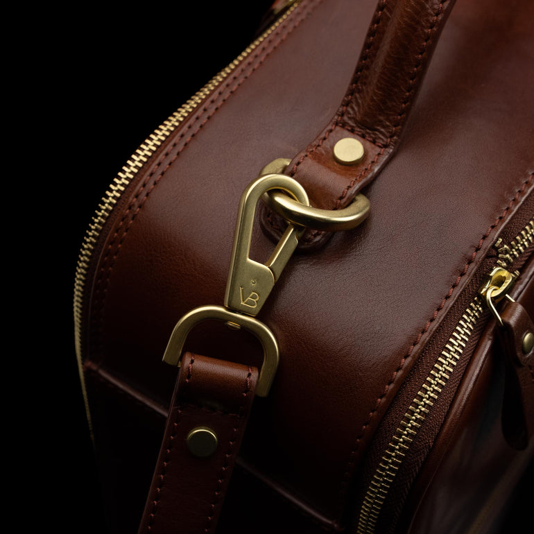 High-quality brown leather laptop travel bag for men with close-up view of brass hardware, made by Von Baer. Durable and stylish craftsmanship detail.