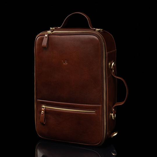 The Von Baer 10x men's high-quality leather laptop travel bag in brown, half-turned view, showcasing its sleek design, adjustable straps, and spacious compartments for convenient and stylish travel.