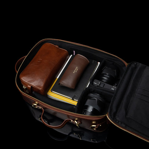 Von Baer 10x spacious leather laptop travel bag/backpack filled with camera gear.
