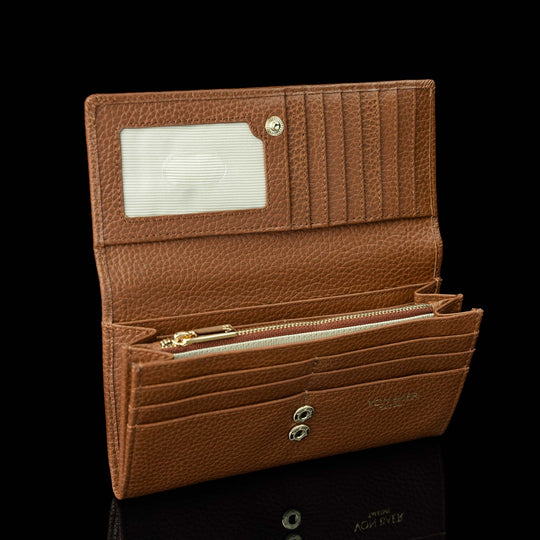 Von Baer Allure large cognac tan full-grain leather accordion wallet with RFID protection, shown open to highlight card slots and an ID window against a black background.