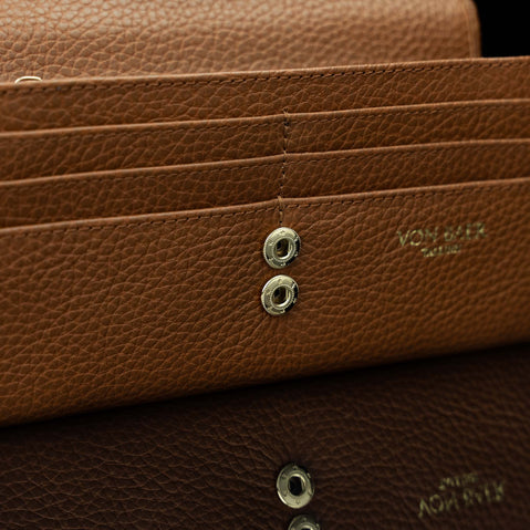 Von Baer Allure large cognac tan full-grain leather accordion wallet with RFID protection, shown in a close-up highlighting the snap button closure.