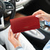 Von Baer Allure large red pebbled leather accordion wallet with gold-tone branding, held in a front view against a blurred Mercedes car interior background.