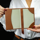 Von Baer Avia luxury leather passport holder open in a woman’s hands