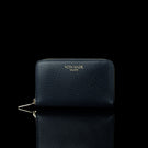 Von Baer Celeste small navy blue full-grain leather zip-around wallet with gold-tone branding, displayed in a front view against a black background.