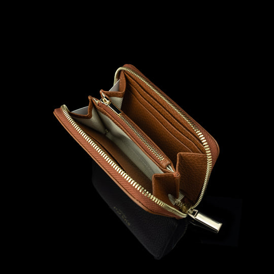 Von Baer Celeste small tan compact full-grain leather zip-around wallet showcased open to display interior card slots, money compartments, and RFID protection, featuring gold-embossed Von Baer Tallinn branding.