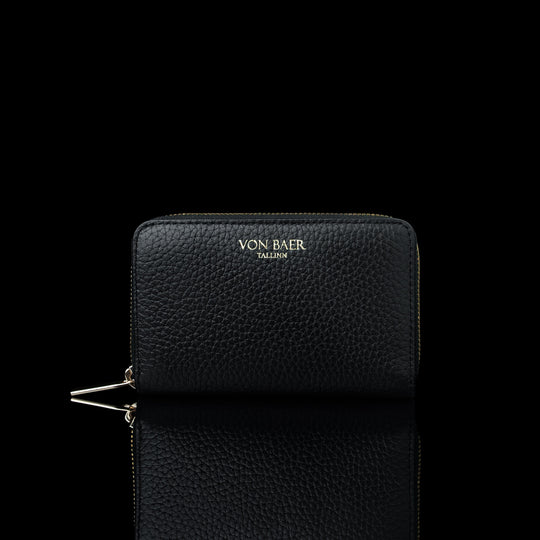 Von Baer Celeste small black full-grain leather zip-around wallet with gold-tone branding, displayed in a front view against a black background.