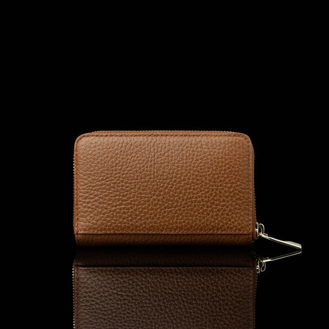 Von Baer Celeste small tan full-grain leather zip-around wallet shown in a back view, featuring RFID protection and premium leather texture against a black background.