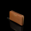 Von Baer Celeste small tan full-grain leather zip-around wallet shown in a side view on a black background, featuring RFID protection, gold-tone zipper hardware, and gold-embossed Von Baer Tallinn branding.