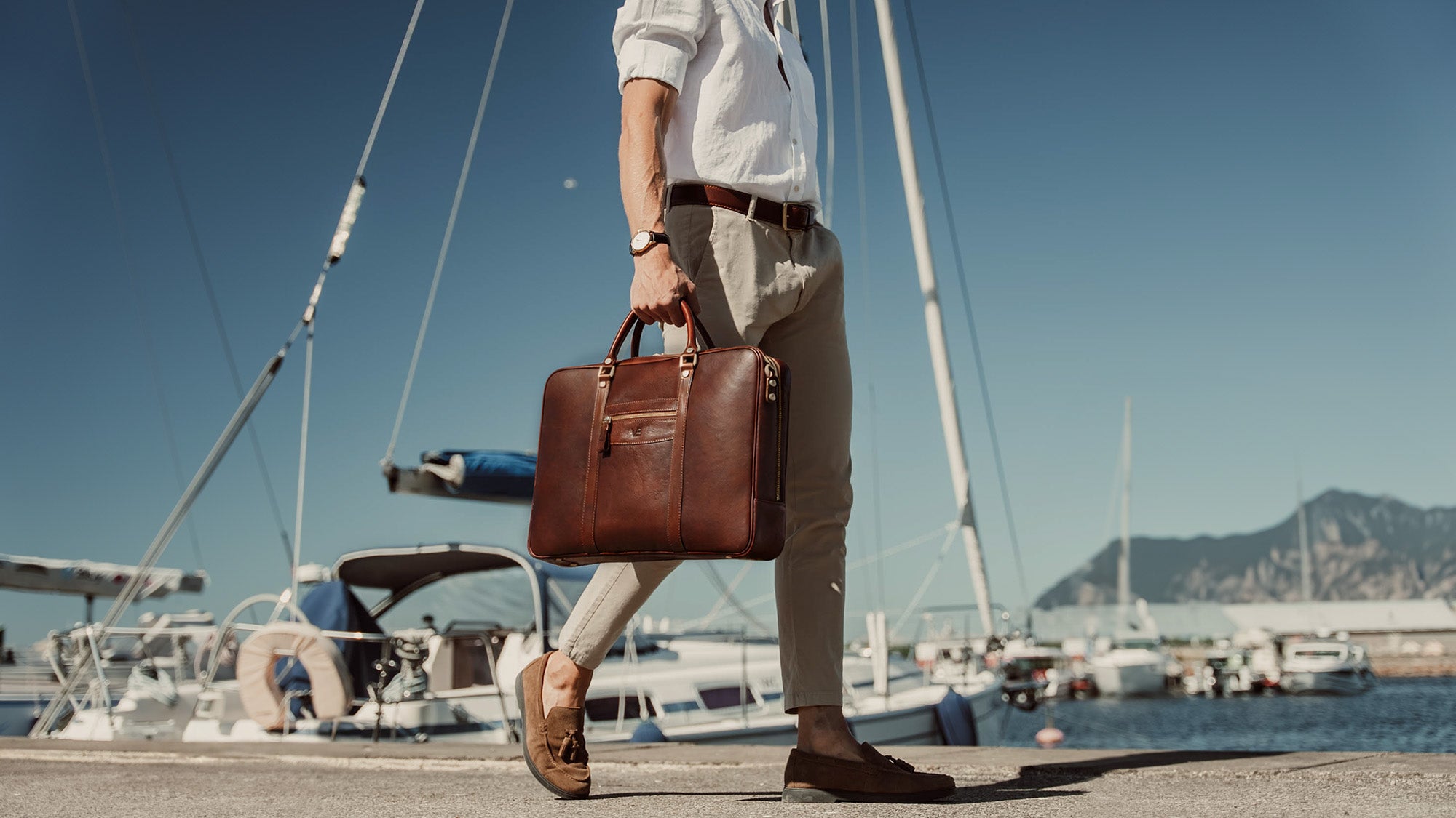 von baer city large leather laptop bag luxury design brown in hands of stylish male model in harbour slider