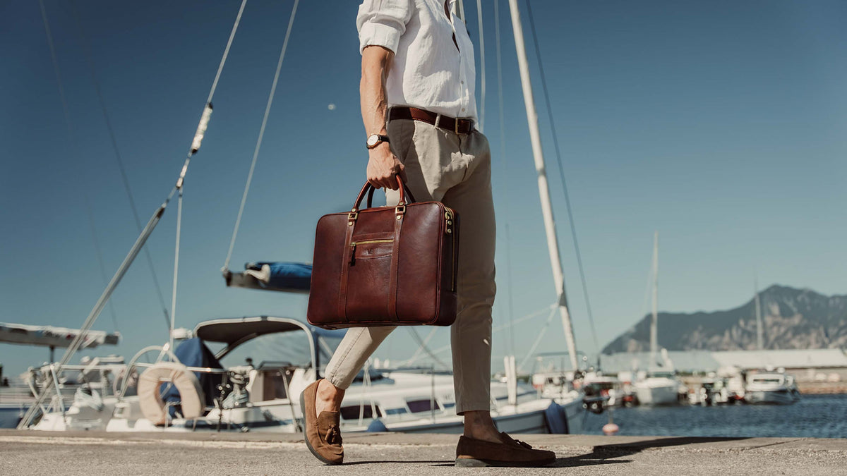 von baer city large leather laptop bag luxury design brown in hands of stylish male model in harbour slider