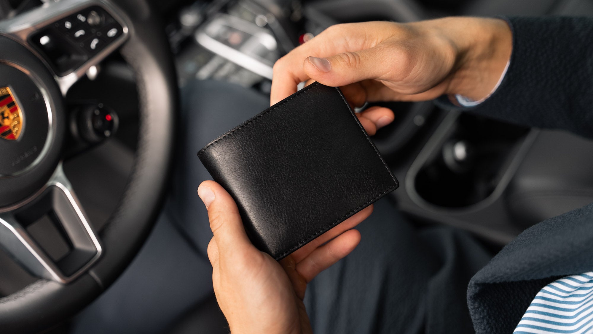 Von Baer Classic bifold luxurious black leather men's wallet held in hands slider view