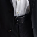 Von Baer classic luxury full-grain leather belt for men in black, with a buckle, worn with a black suit.