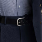 Von Baer classic luxury full-grain leather belt for men in black, with a silver stainless steel buckle, lifestyle shot.