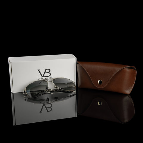 A brown Von Baer Deluxe luxury leather glasses and sunglasses case with a gift box and glasses.