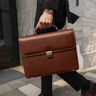 Luxurious premium full-grain leather briefcase by von baer for men in a business city lifestyle setting.