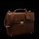 Compact full-grain leather laptop briefcase with shoulder strap and luggage tag for professional work, brown perspective view by Von Baer diplomat.