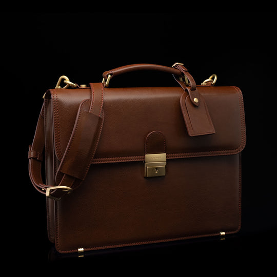 Compact full-grain leather laptop briefcase with shoulder strap and luggage tag for professional work, brown perspective view by Von Baer diplomat.