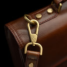 Von Baer diplomat men’s compact full-grain leather briefcase VB logo metal hardware close-up showing premium brand detail.