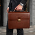 Von Baer diplomat men’s classic compact full-grain leather briefcase in brown, city setting for businessman and professional work.