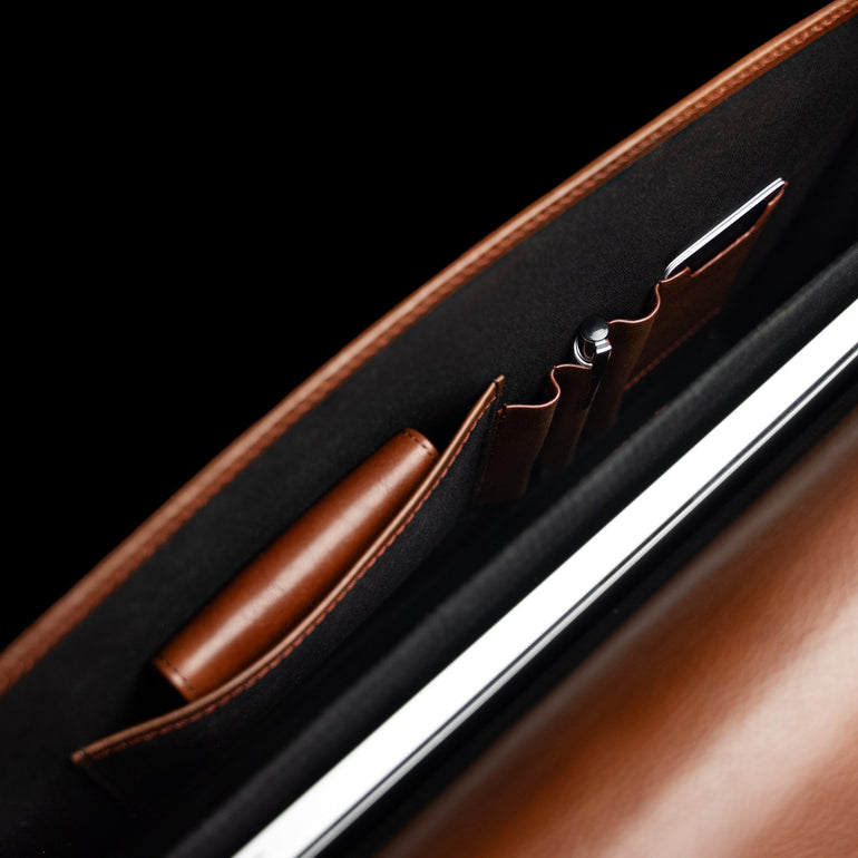 Von Baer Diplomat slim full-grain leather briefcase interior top view showing organized compartments for laptop, documents, and professional work.