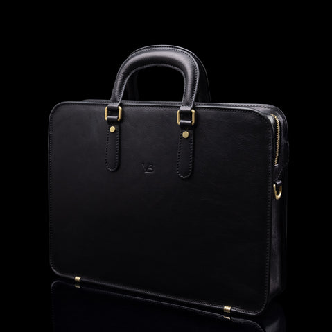 Von Baer Elegant high-quality slim full-grain leather laptop bag in black, half-turned, for women.
