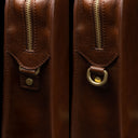 Von Baer Elegant high-quality slim full-grain leather women’s laptop bag in brown, half-turned side view with brass rings.