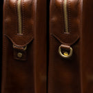 Von Baer Elegant high-quality slim full-grain leather women’s laptop bag in brown, half-turned side view with brass rings.