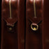 Von Baer Elegant high-quality slim full-grain leather women’s laptop bag in brown, half-turned side view with brass rings.