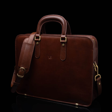 Von Baer Elegant high-quality slim full-grain leather women’s laptop bag in brown, with an adjustable shoulder strap.