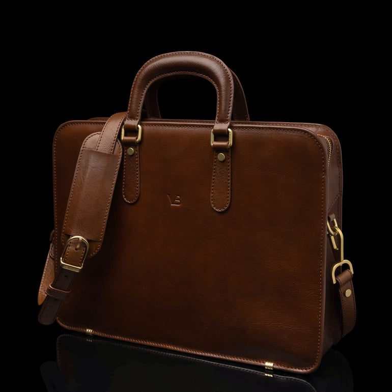 Von Baer Elegant high-quality slim full-grain leather women’s laptop bag in brown, with an adjustable shoulder strap.