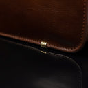 Von Baer Elegant high-quality slim full-grain leather women’s laptop bag in brown, close-up showing protective metal feet.