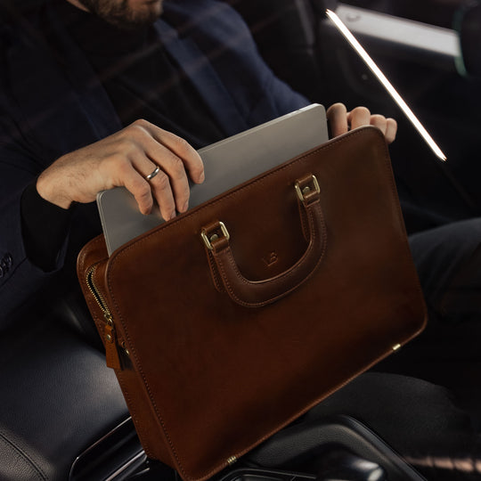 Von Baer Elegant luxury slim full-grain leather laptop bag in Porsche with businessman taking out MacBook