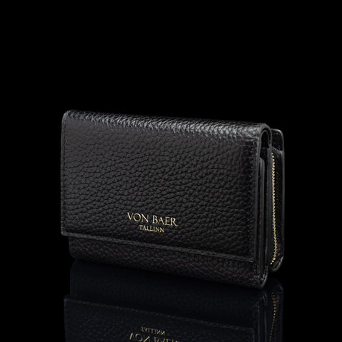 Von Baer Elise women's black pebbled leather trifold wallet shown from a three-quarter front view on a reflective black background, featuring gold-embossed Von Baer Tallinn branding and a gold zipper.