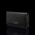 Von Baer Elise women's black pebbled leather trifold wallet shown from a three-quarter front view on a reflective black background, featuring gold-embossed Von Baer Tallinn branding and a gold zipper.
