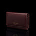 Von Baer Elise women's burgundy pebbled leather trifold wallet shown from a three-quarter front view on a reflective black surface, featuring gold-embossed Von Baer Tallinn branding.