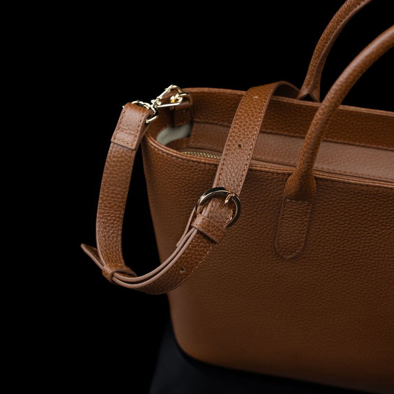 Von Baer Estelle brown leather crossbody tote bag for women, shown from the rear three-quarter view with adjustable shoulder strap, buckle and gold-tone hardware.