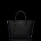 Von Baer Estelle black leather tote bag for women, shown from the front with structured top handles, pebbled leather texture, leather clochette and gold-tone logo.