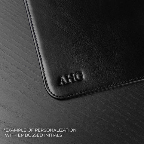 Von Baer black leather mat featuring custom initials embossing detail, showcasing personalized craftsmanship on a premium leather desk accessory.