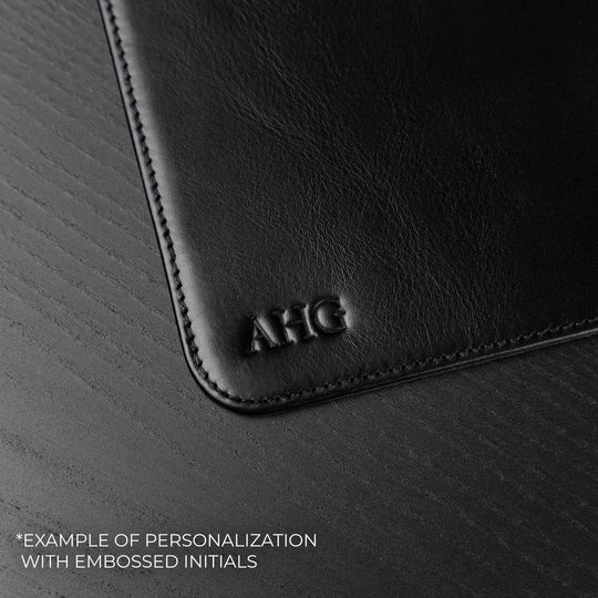 Von Baer black leather mat featuring custom initials embossing detail, showcasing personalized craftsmanship on a premium leather desk accessory.