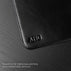 Von Baer black leather mat featuring custom initials embossing detail, showcasing personalized craftsmanship on a premium leather desk accessory.